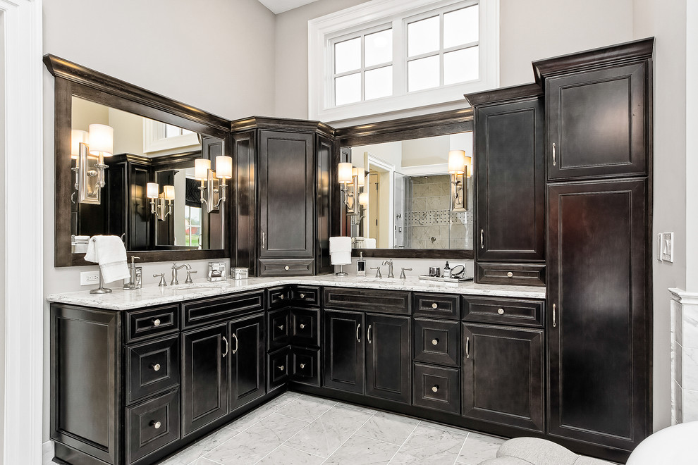 Inspiration for a large transitional master marble floor and gray floor freestanding bathtub remodel in Columbus with beaded inset cabinets, dark wood cabinets, beige walls, an undermount sink and white countertops