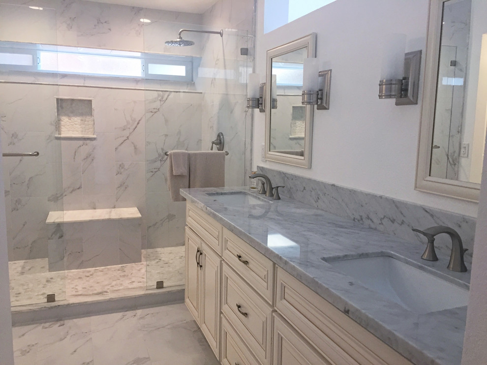 Medium sized classic ensuite bathroom in San Diego with raised-panel cabinets, distressed cabinets, an alcove shower, a two-piece toilet, white tiles, marble tiles, white walls, marble flooring, a trough sink, marble worktops, white floors and an open shower.