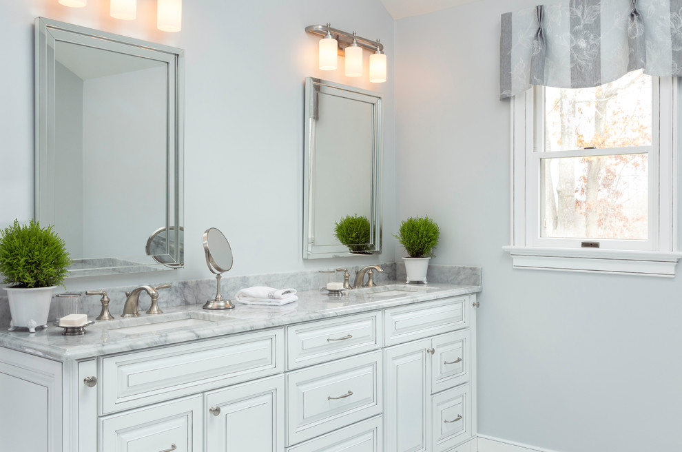 Large transitional master white tile marble floor bathroom photo in Philadelphia with raised-panel cabinets, white cabinets, an undermount tub, gray walls, an undermount sink and marble countertops