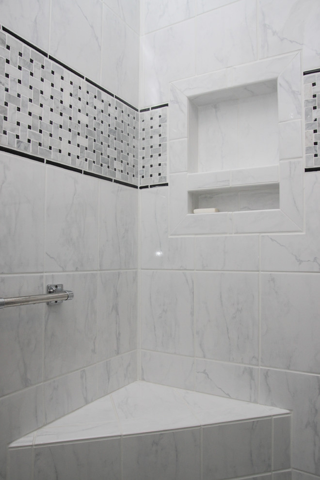 This is an example of a small contemporary ensuite bathroom in Raleigh with glass-front cabinets, dark wood cabinets, an alcove shower, white tiles, stone tiles, blue walls, mosaic tile flooring and a vessel sink.
