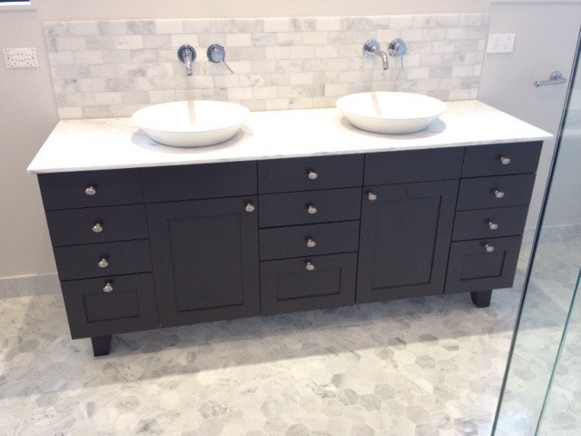 Inspiration for a large classic ensuite bathroom in Auckland with shaker cabinets, brown cabinets, a freestanding bath, a built-in shower, a two-piece toilet, white tiles, stone tiles, beige walls, marble flooring, a vessel sink and marble worktops.