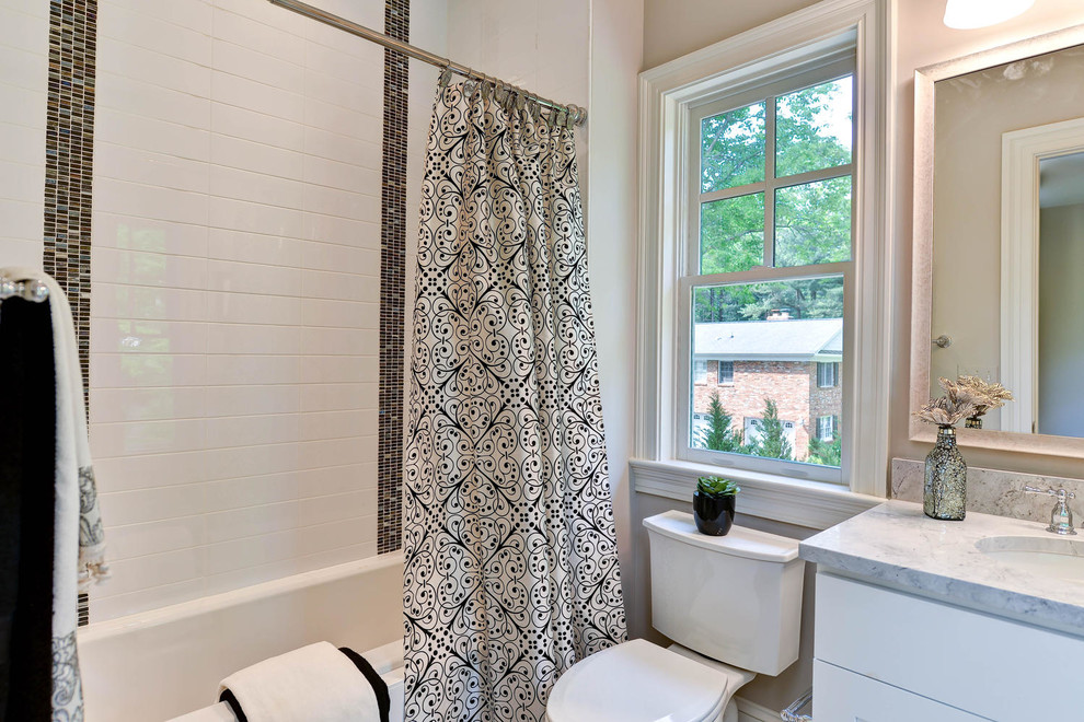This is an example of a medium sized traditional family bathroom in DC Metro with recessed-panel cabinets, white cabinets, an alcove bath, an alcove shower, a one-piece toilet, white tiles, ceramic tiles, white walls, an integrated sink and marble worktops.