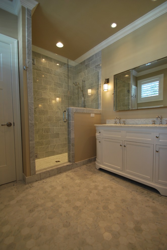 This is an example of a medium sized traditional shower room bathroom in DC Metro with beaded cabinets, white cabinets, an alcove shower, a two-piece toilet, grey tiles, marble tiles, beige walls, marble flooring, a submerged sink, marble worktops, grey floors, a hinged door and grey worktops.