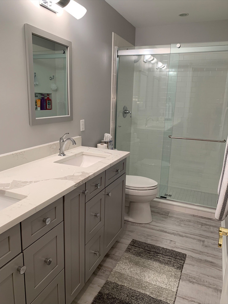 This is an example of a contemporary family bathroom in Baltimore with shaker cabinets, grey cabinets, a submerged sink, engineered stone worktops, white worktops, double sinks and a freestanding vanity unit.