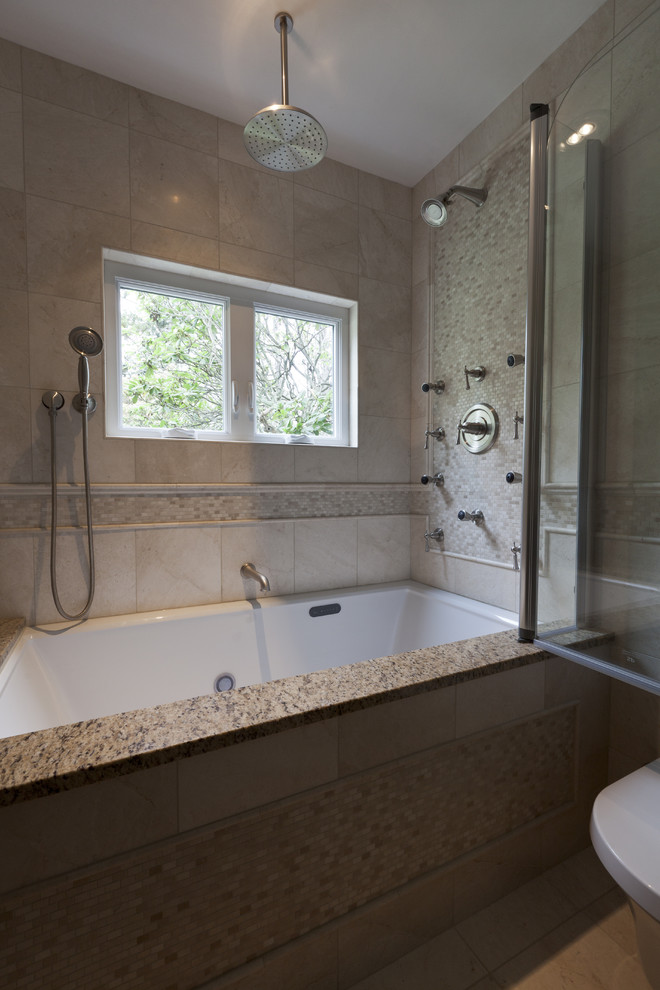 Example of a small classic beige tile and stone tile marble floor tub/shower combo design in Bridgeport with an undermount sink, shaker cabinets, dark wood cabinets, granite countertops, an undermount tub, a wall-mount toilet and beige walls