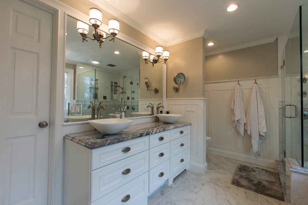 Mid-sized transitional master white tile and porcelain tile porcelain tile corner shower photo in Bridgeport with a vessel sink, raised-panel cabinets, white cabinets, granite countertops, an undermount tub, a two-piece toilet and beige walls