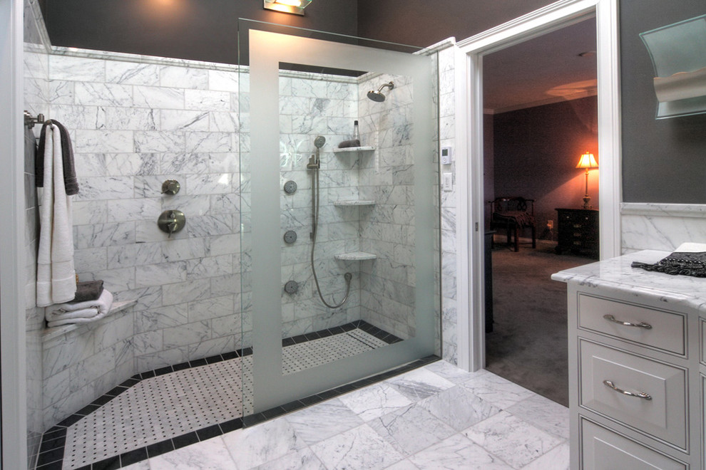 Example of a large classic master black and white tile and stone tile marble floor walk-in shower design in St Louis with raised-panel cabinets, white cabinets, a two-piece toilet, gray walls, an undermount sink and marble countertops