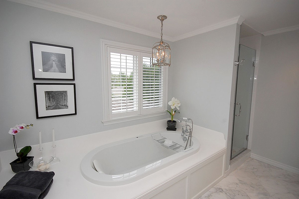 Drop-in bathtub - traditional white tile and stone tile drop-in bathtub idea in Toronto