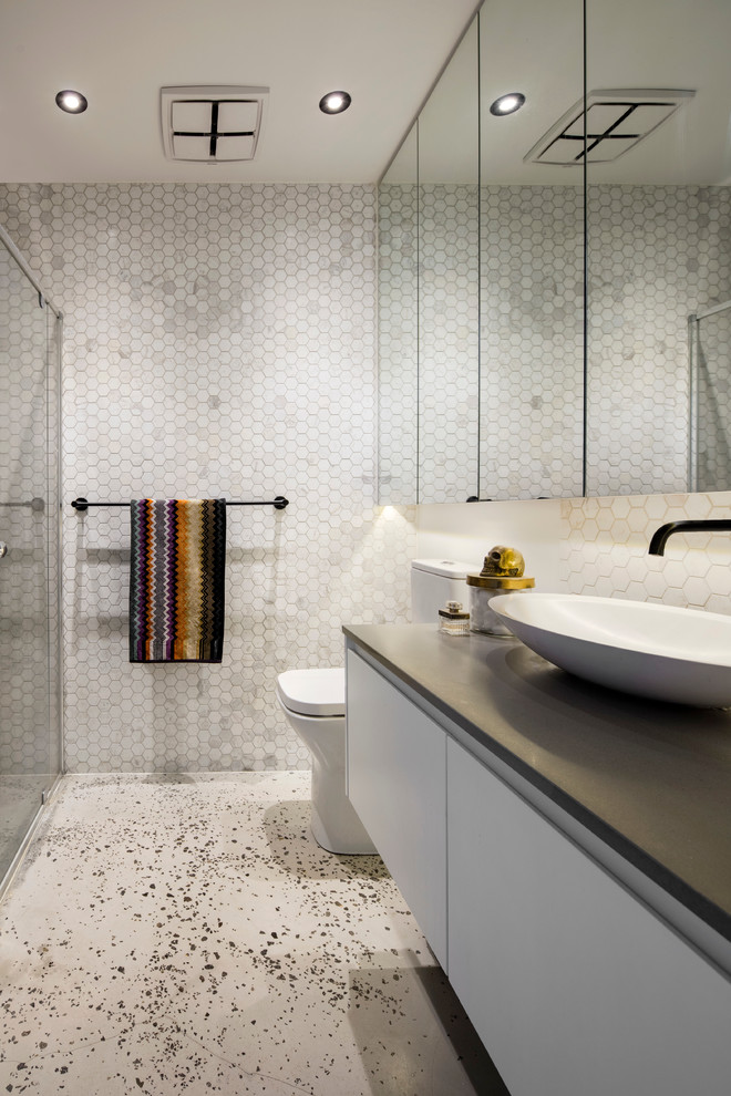 Example of a mid-sized trendy mosaic tile concrete floor bathroom design in Melbourne with white cabinets, white walls and marble countertops