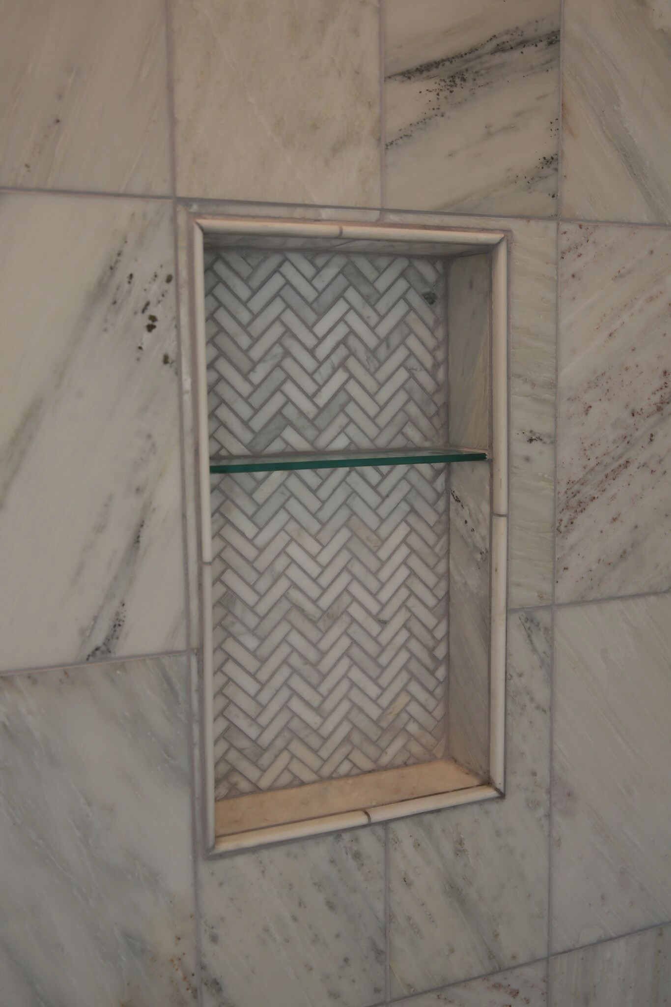 Shower Shelf Detail In Wall Of Herringbone Marble Tiles Stock