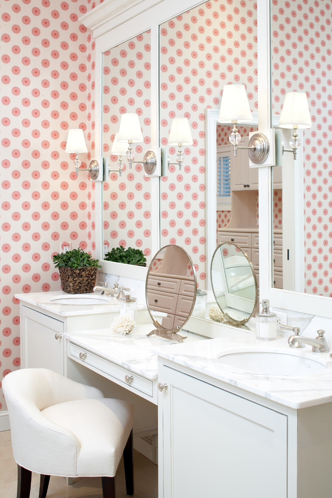 Photo of a large beach style ensuite bathroom in Boston with marble worktops, a submerged sink, recessed-panel cabinets, white cabinets, a freestanding bath, a corner shower, stone tiles and pink walls.