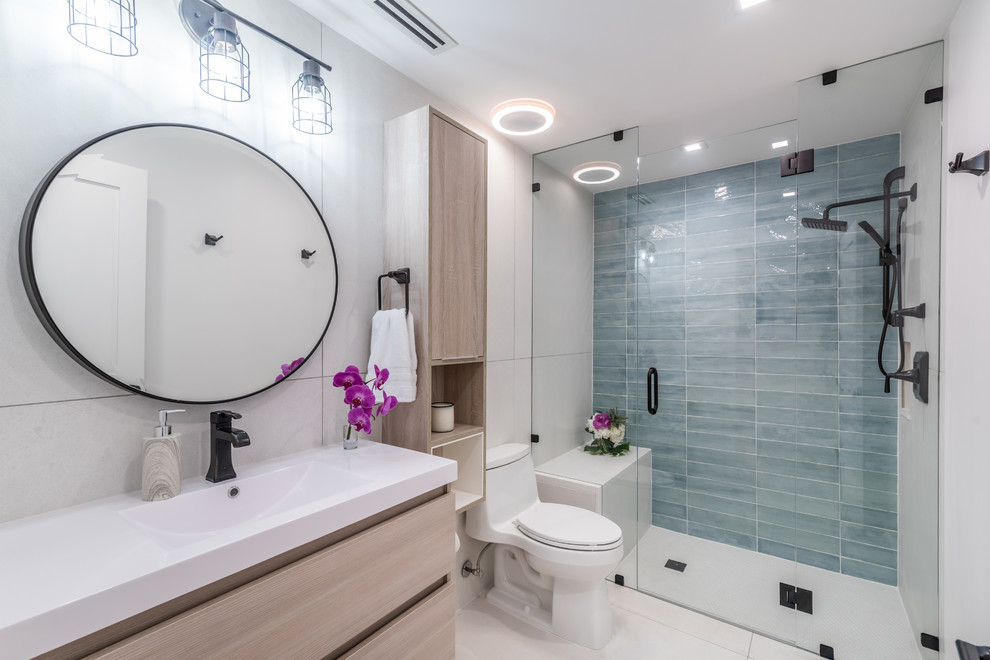 Design ideas for a medium sized nautical shower room bathroom with flat-panel cabinets, light wood cabinets, a built-in shower, a one-piece toilet, white tiles, porcelain tiles, white walls, porcelain flooring, a submerged sink, engineered stone worktops, white floors, a hinged door and white worktops.