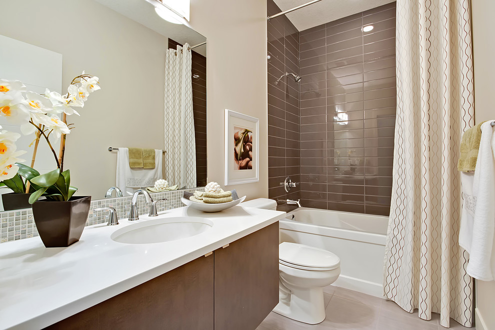 Bathroom - mid-sized modern brown tile and porcelain tile porcelain tile bathroom idea in Calgary with flat-panel cabinets, white cabinets, a two-piece toilet, beige walls, an undermount sink and quartz countertops
