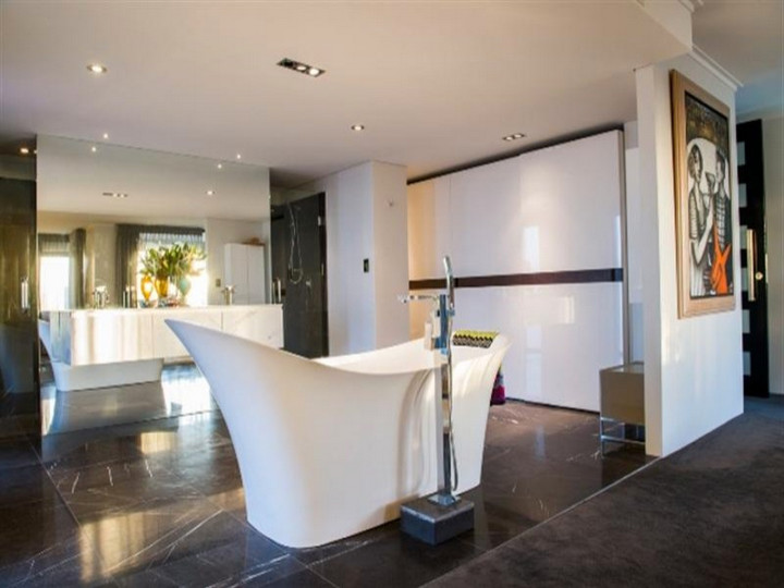 Example of a large trendy master gray tile and stone tile terrazzo floor bathroom design in Perth with an integrated sink, flat-panel cabinets, white cabinets, marble countertops, a wall-mount toilet and white walls