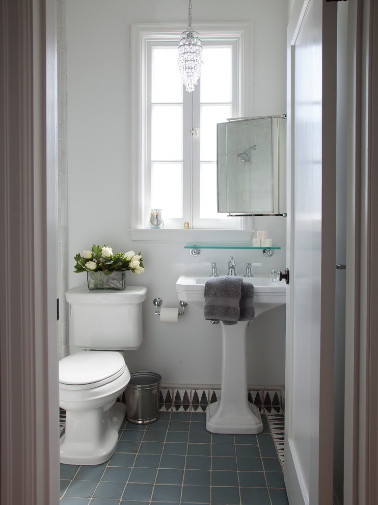 Photo of a medium sized mediterranean bathroom in San Francisco with a pedestal sink, an alcove shower, multi-coloured tiles, terracotta tiles, white walls, terracotta flooring, a two-piece toilet, blue floors and feature lighting.