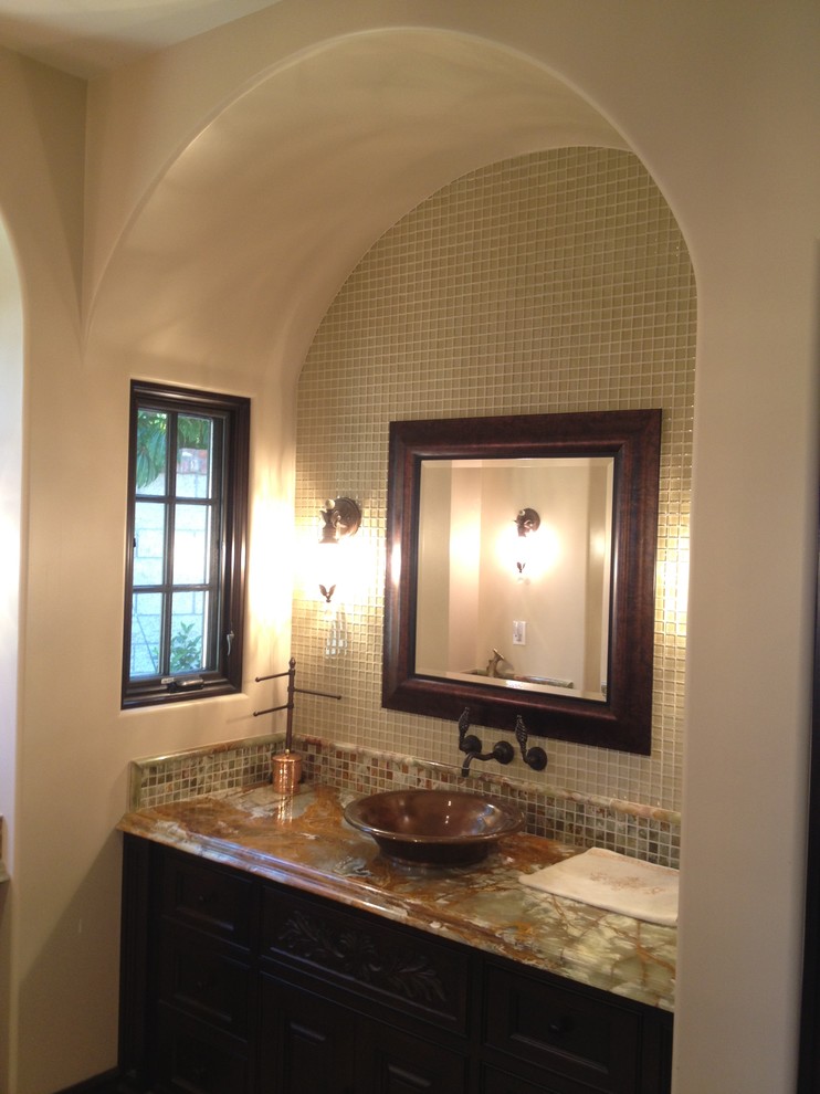 This is an example of a large mediterranean ensuite wet room bathroom in Orange County with dark wood cabinets, beige walls, a vessel sink, open cabinets, limestone tiles and an open shower.