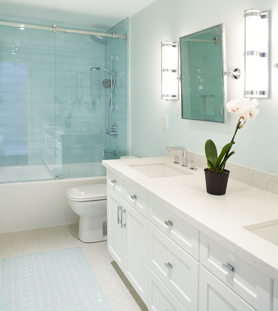 Traditional bathroom in Toronto with a submerged sink, shaker cabinets, white cabinets, engineered stone worktops, an alcove bath, a shower/bath combination, a two-piece toilet and blue tiles.