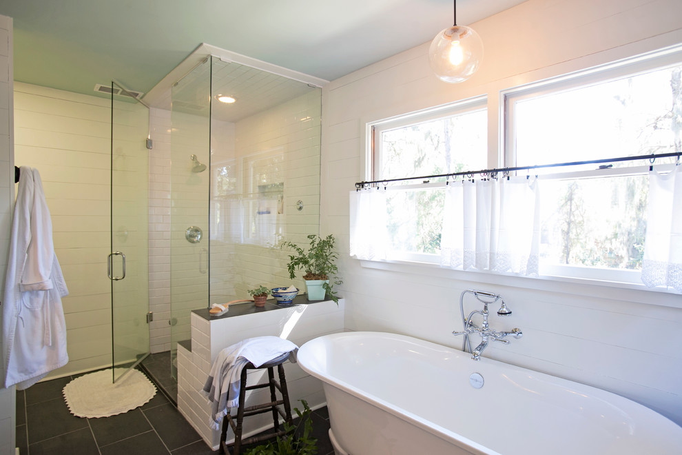 Example of a mid-sized cottage master white tile and subway tile ceramic tile and black floor bathroom design in Atlanta with an undermount sink, soapstone countertops, white walls, louvered cabinets, medium tone wood cabinets and a hinged shower door