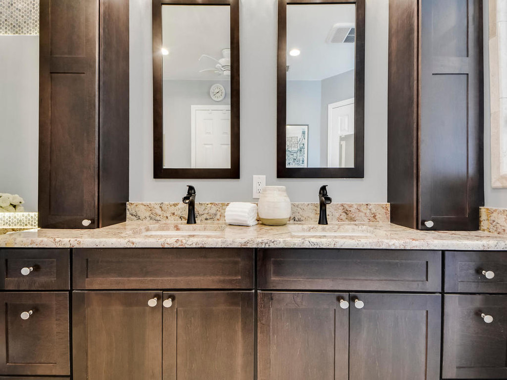 This is an example of a medium sized contemporary ensuite bathroom in Austin with flat-panel cabinets, dark wood cabinets, a corner shower, green tiles, glass tiles, brown walls, a built-in sink and granite worktops.