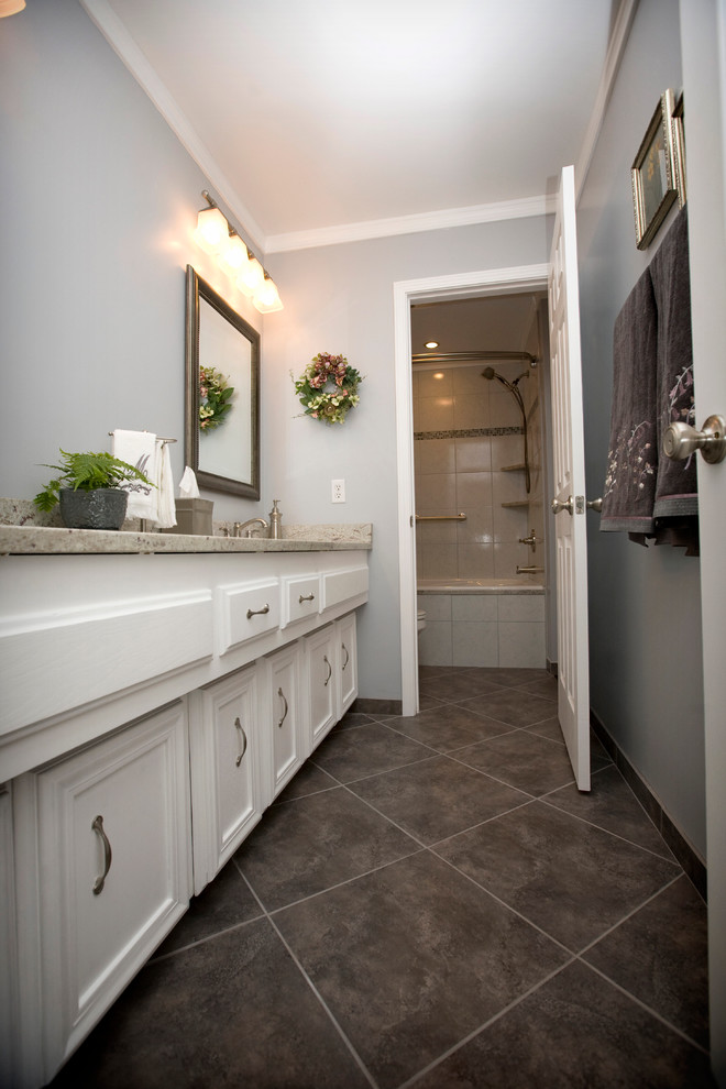 Inredning av ett klassiskt mellanstort en-suite badrum, med ett undermonterad handfat, vita skåp, en dusch/badkar-kombination, grå väggar, luckor med infälld panel, ett platsbyggt badkar, en toalettstol med separat cisternkåpa, klinkergolv i porslin och granitbänkskiva