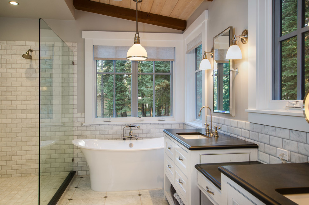 Inspiration for a large rustic ensuite bathroom in San Francisco with a submerged sink, beaded cabinets, white cabinets, soapstone worktops, a freestanding bath, a walk-in shower, white tiles, metro tiles, grey walls, marble flooring and an open shower.