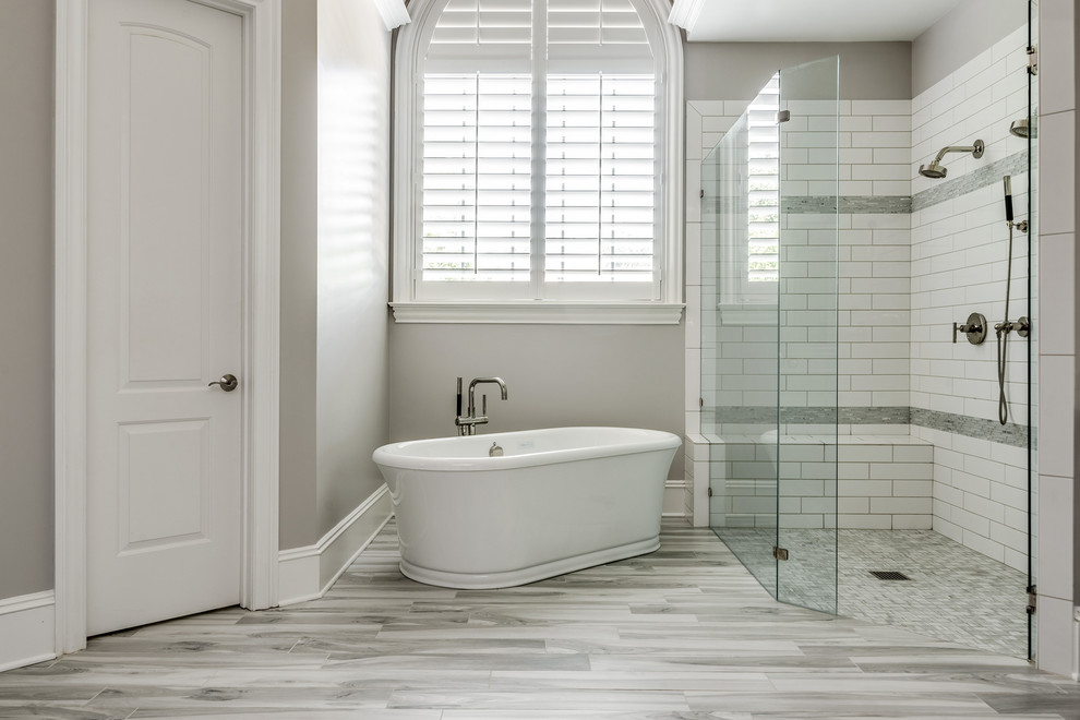 Example of a large transitional master gray tile and terra-cotta tile porcelain tile and gray floor bathroom design in Charlotte with gray cabinets, gray walls, an undermount sink, quartz countertops, a hinged shower door and gray countertops