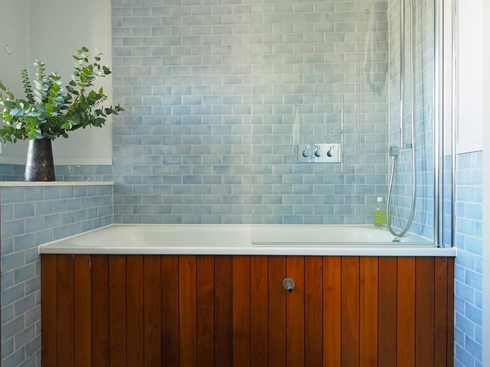 Inspiration for a transitional blue tile and subway tile bathroom remodel in London
