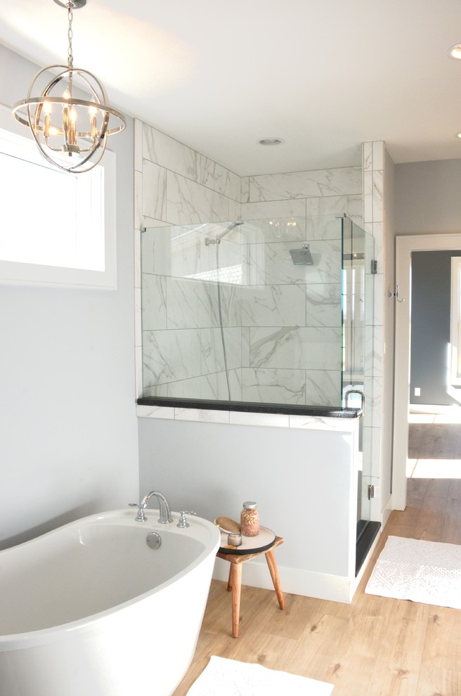 Example of a cottage master porcelain tile vinyl floor bathroom design in Other with shaker cabinets, white cabinets, gray walls, an undermount sink, quartz countertops, a hinged shower door and gray countertops