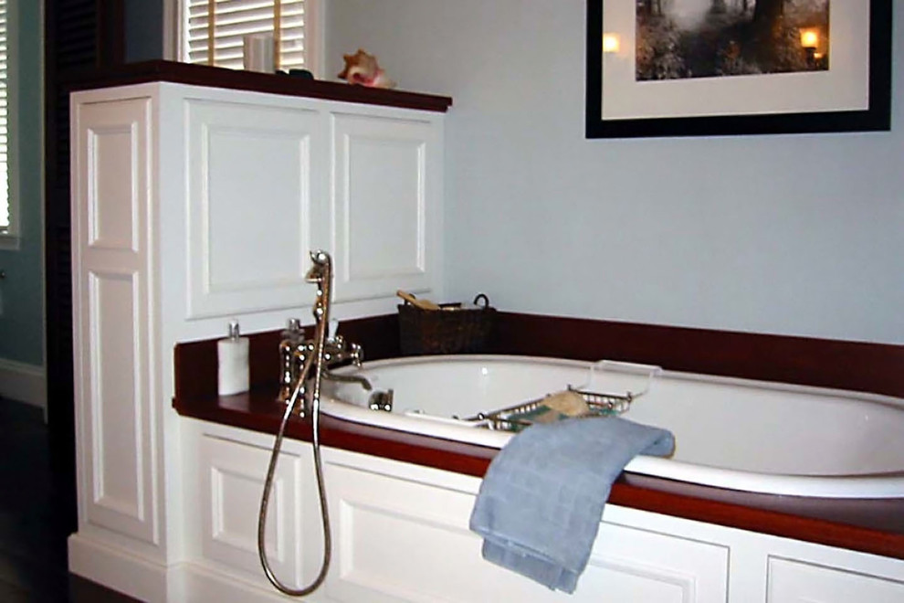 Large elegant master dark wood floor and brown floor bathroom photo in Boston with raised-panel cabinets, white cabinets, a one-piece toilet, a drop-in sink, wood countertops and a hinged shower door