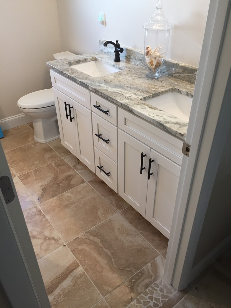 Inspiration for a small timeless kids' multicolored floor and porcelain tile bathroom remodel in Tampa with shaker cabinets, white cabinets, an undermount sink, granite countertops, a two-piece toilet and beige walls
