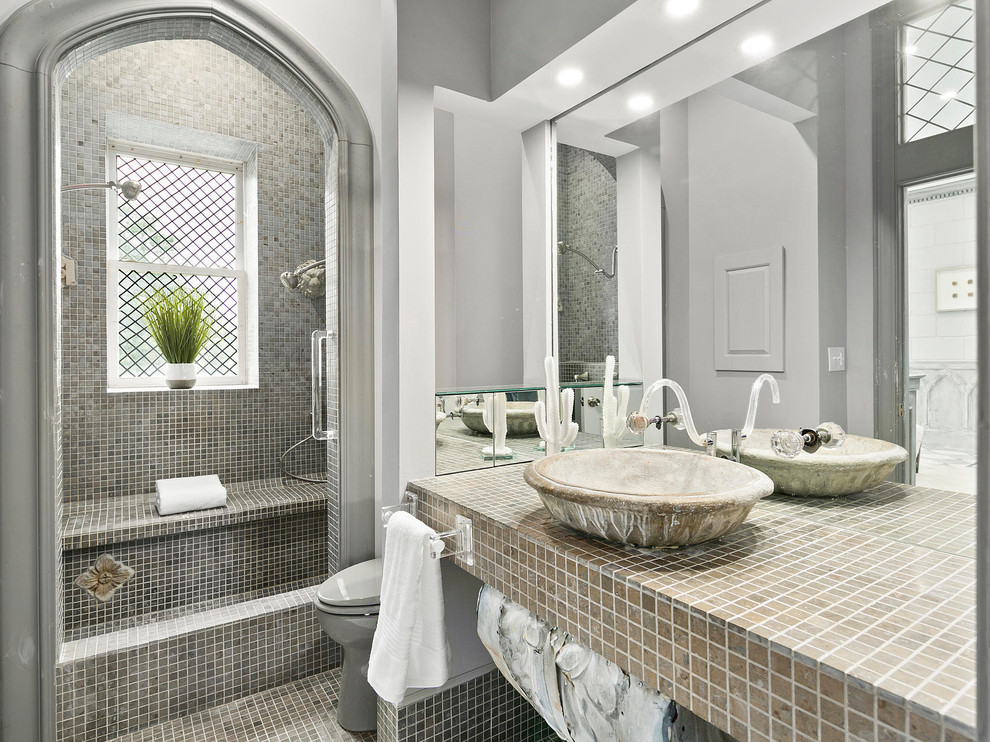 На фото: ванная комната в стиле шебби-шик с серой плиткой, плиткой мозаикой, серыми стенами, полом из мозаичной плитки, настольной раковиной, столешницей из плитки и окном