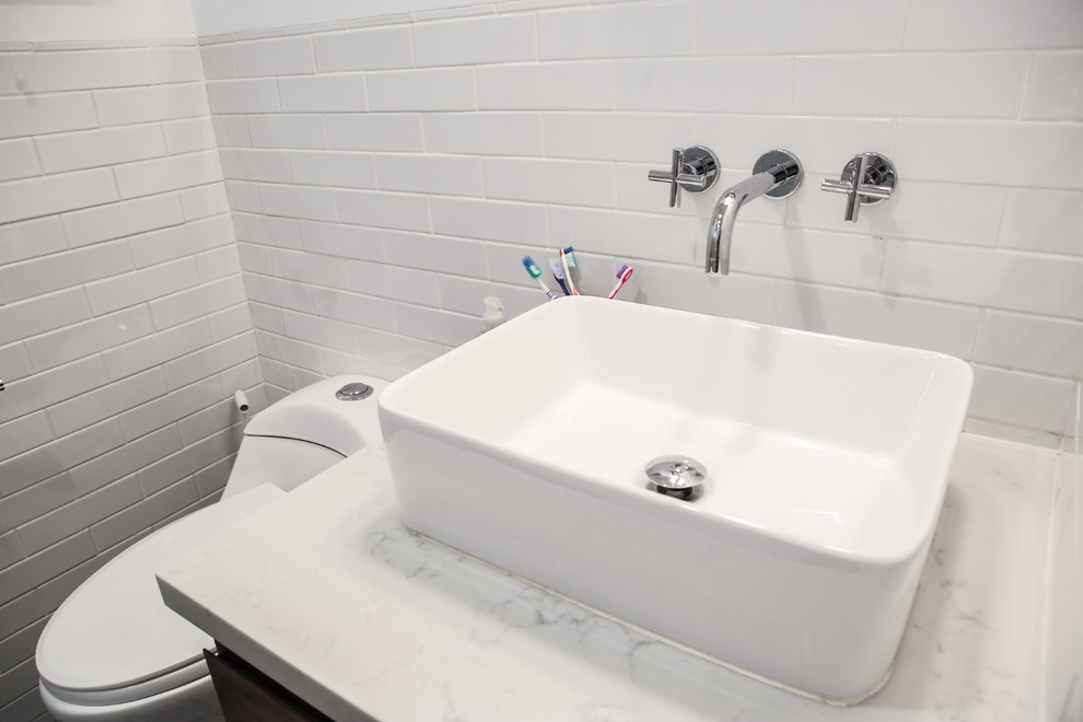 Inspiration for a small contemporary white tile and subway tile ceramic tile and turquoise floor bathroom remodel in Los Angeles with medium tone wood cabinets, a one-piece toilet, white walls, a vessel sink, quartzite countertops and white countertops