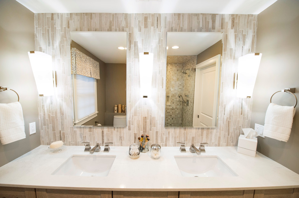 Large traditional ensuite bathroom in Boston with flat-panel cabinets, white cabinets, a corner shower, a one-piece toilet, white tiles, glass sheet walls, brown walls, ceramic flooring, a submerged sink, beige floors and a hinged door.