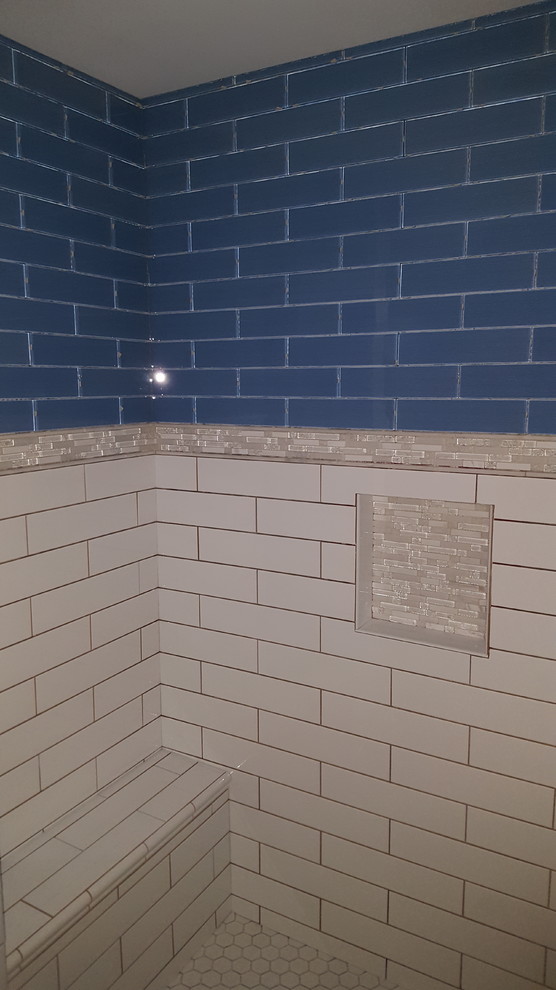 Design ideas for a small classic shower room bathroom in Cincinnati with recessed-panel cabinets, black cabinets, an alcove shower, a two-piece toilet, blue tiles, glass tiles, grey walls, porcelain flooring, a submerged sink and engineered stone worktops.
