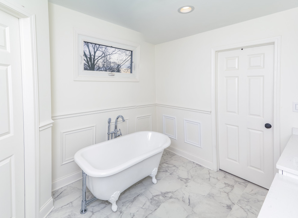 Design ideas for a contemporary ensuite bathroom in Chicago with white cabinets, a freestanding bath, a walk-in shower, a one-piece toilet, cement tiles, white walls, cement flooring, a sliding door and white worktops.