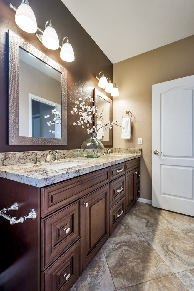 Inspiration for a medium sized traditional family bathroom in Phoenix with raised-panel cabinets, brown cabinets, a built-in bath, a shower/bath combination, a one-piece toilet, beige tiles, porcelain tiles, brown walls, a built-in sink, granite worktops and a shower curtain.