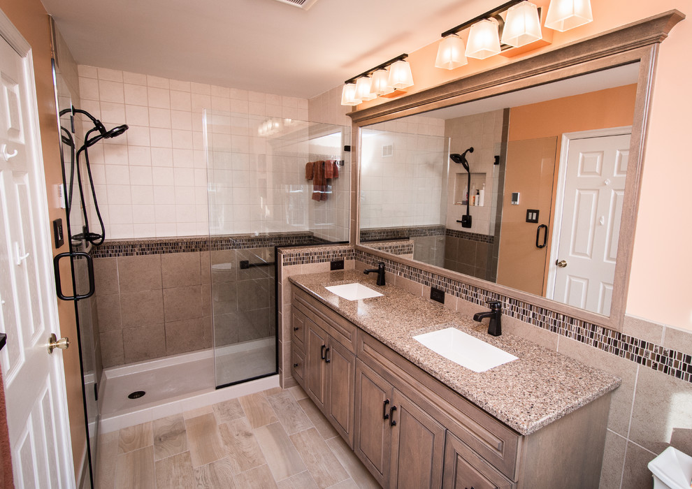 Example of a small master gray tile and porcelain tile porcelain tile alcove shower design in Philadelphia with raised-panel cabinets, gray cabinets, a two-piece toilet, orange walls, an undermount sink and quartz countertops
