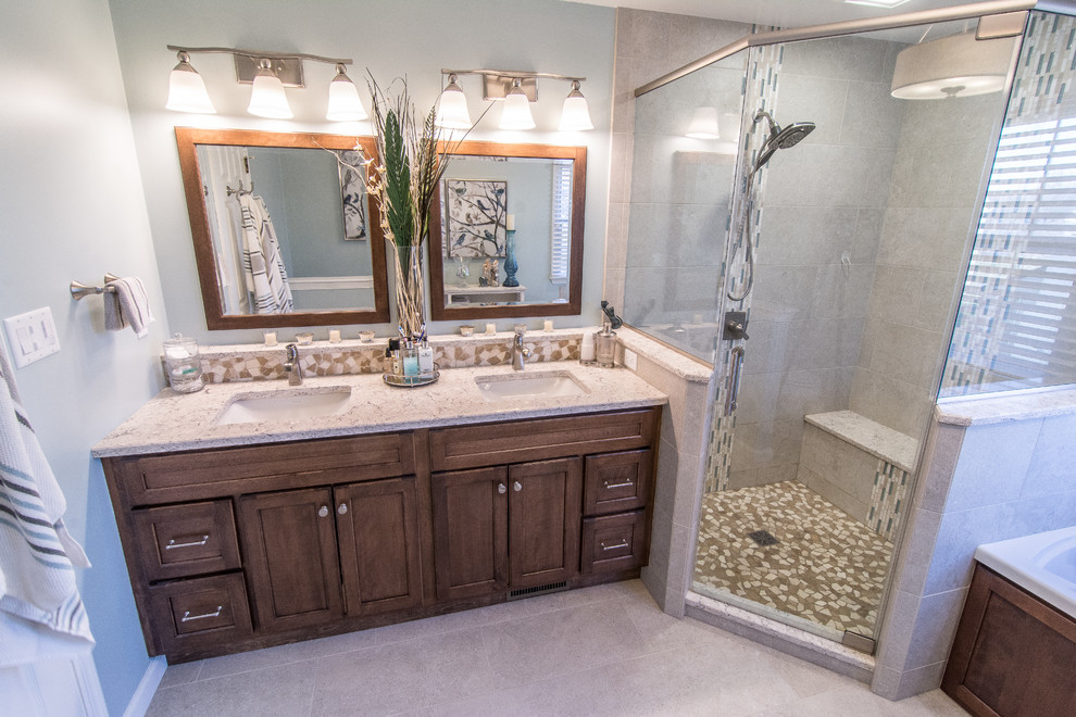 Example of a mid-sized classic master beige tile and porcelain tile porcelain tile and beige floor bathroom design in Philadelphia with flat-panel cabinets, dark wood cabinets, a two-piece toilet, blue walls, an undermount sink, quartz countertops and a hinged shower door