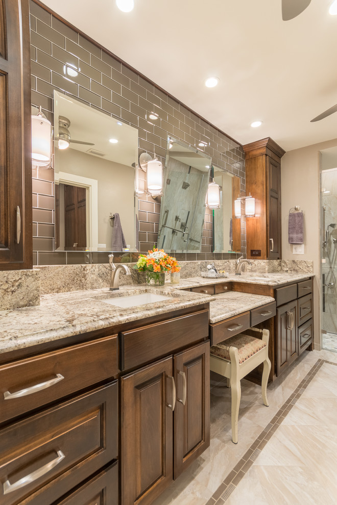 Example of a mid-sized transitional 3/4 gray tile and glass tile porcelain tile walk-in shower design in Austin with raised-panel cabinets, medium tone wood cabinets, a wall-mount toilet, beige walls, an undermount sink and granite countertops