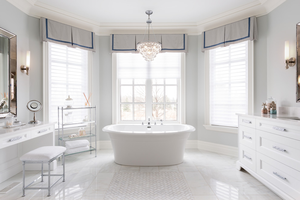 Inspiration for a classic bathroom in Toronto with a submerged sink, recessed-panel cabinets, white cabinets, a freestanding bath and grey walls.