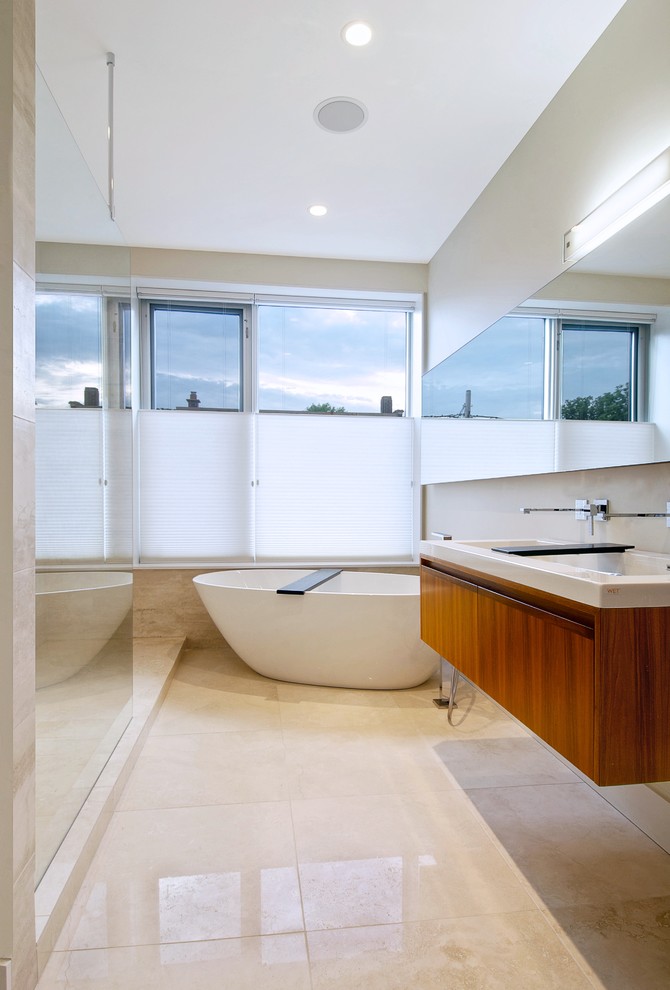 Photo of a modern bathroom in Toronto with a freestanding bath and feature lighting.