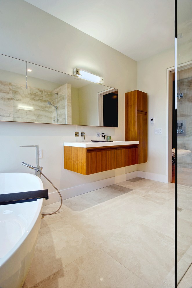 Photo of a modern bathroom in Toronto with a freestanding bath and feature lighting.