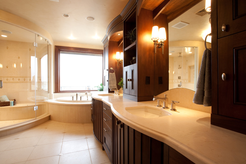 Идея дизайна: ванная комната в современном стиле с врезной раковиной, темными деревянными фасадами, накладной ванной, угловым душем и бежевой плиткой