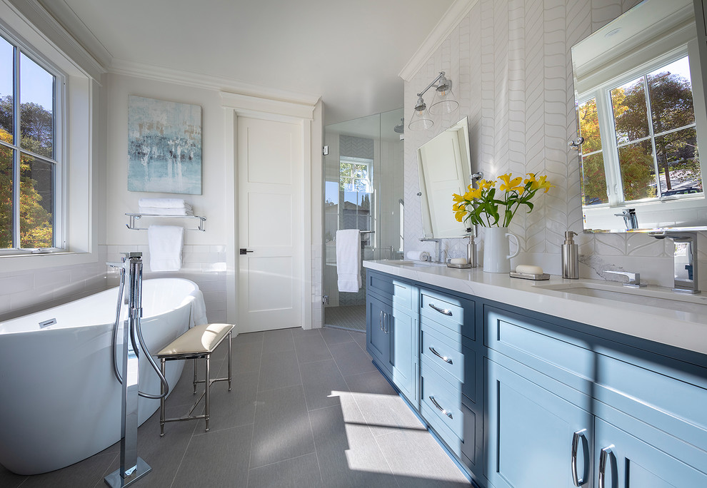 Inspiration for a small country master white tile and ceramic tile porcelain tile and gray floor bathroom remodel in San Francisco with shaker cabinets, blue cabinets, a two-piece toilet, white walls, an undermount sink, quartz countertops, a hinged shower door and white countertops
