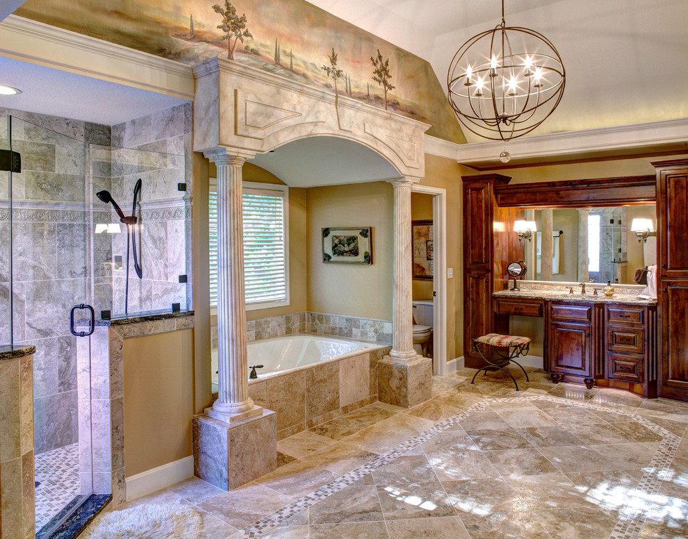 Large tuscan master beige tile and mosaic tile travertine floor alcove bathtub photo in Kansas City with raised-panel cabinets, dark wood cabinets, beige walls, a pedestal sink and granite countertops