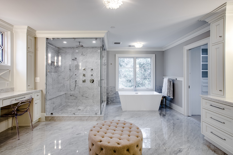Photo of a large classic ensuite wet room bathroom in DC Metro with recessed-panel cabinets, white cabinets, a freestanding bath, a two-piece toilet, multi-coloured tiles, marble tiles, grey walls, marble flooring, an integrated sink, marble worktops, multi-coloured worktops, white floors and a hinged door.