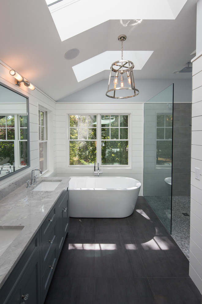 Design ideas for a large classic ensuite bathroom in Boston with recessed-panel cabinets, grey cabinets, a freestanding bath, a built-in shower, a one-piece toilet, grey tiles, porcelain tiles, blue walls, porcelain flooring, a submerged sink and quartz worktops.