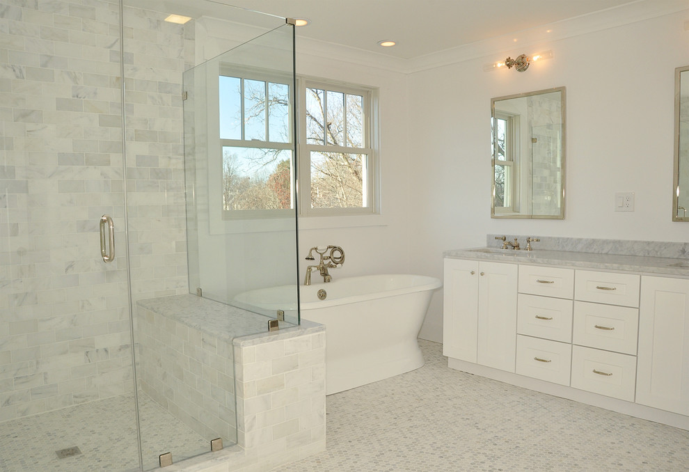 Large classic ensuite bathroom in Boston with shaker cabinets, white cabinets, a freestanding bath, a corner shower, a two-piece toilet, stone tiles, white walls, marble flooring, a submerged sink and marble worktops.