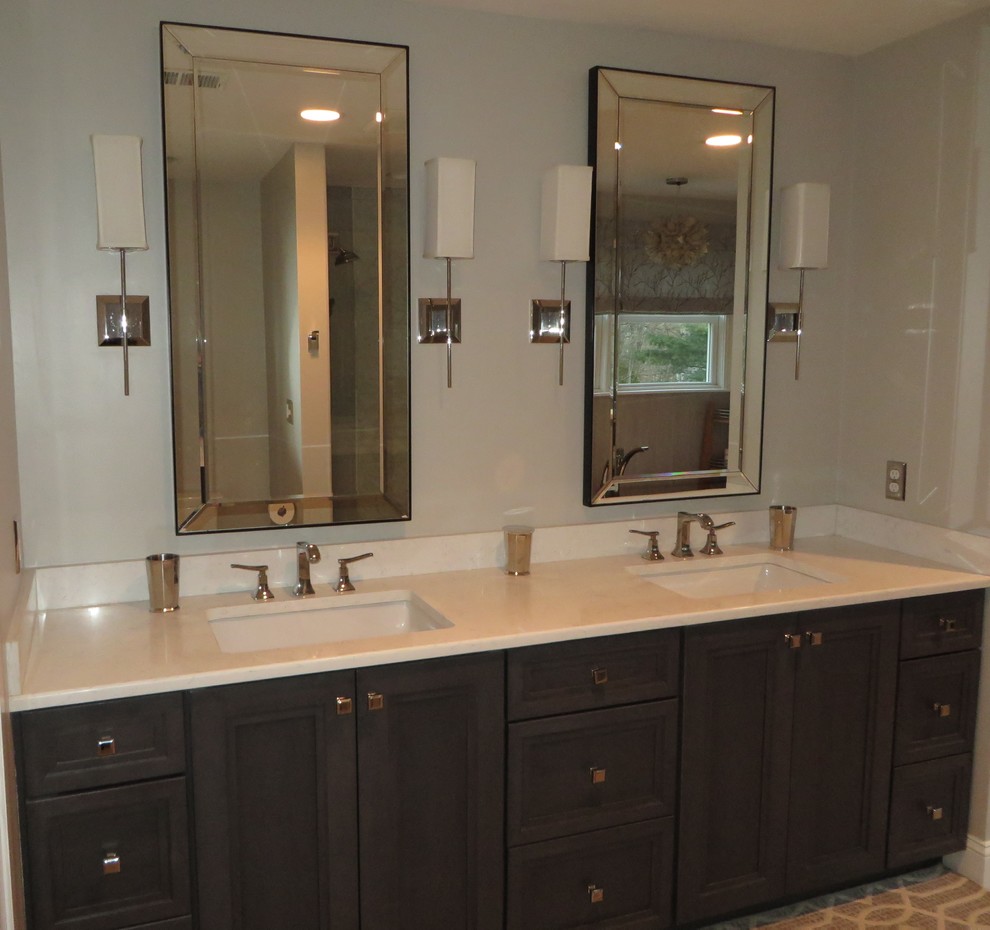 Example of a transitional master green tile and porcelain tile porcelain tile and beige floor bathroom design in Boston with recessed-panel cabinets, an undermount sink, quartz countertops, brown cabinets, a one-piece toilet, green walls and a hinged shower door