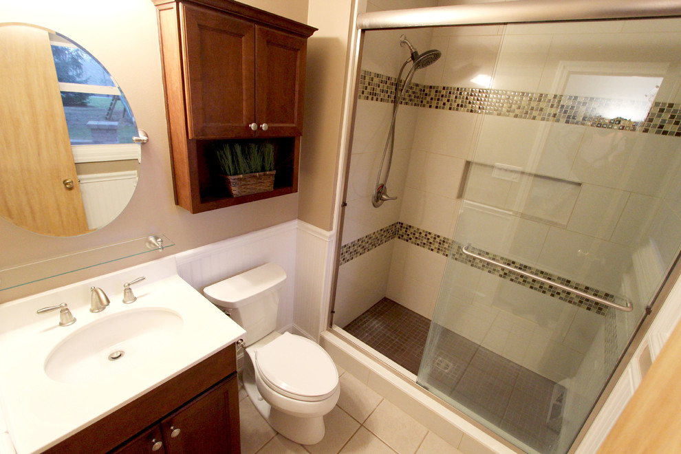 Inspiration for a small traditional ensuite bathroom in Cleveland with recessed-panel cabinets, medium wood cabinets, an alcove shower, white tiles, ceramic tiles, beige walls, ceramic flooring, a submerged sink and marble worktops.